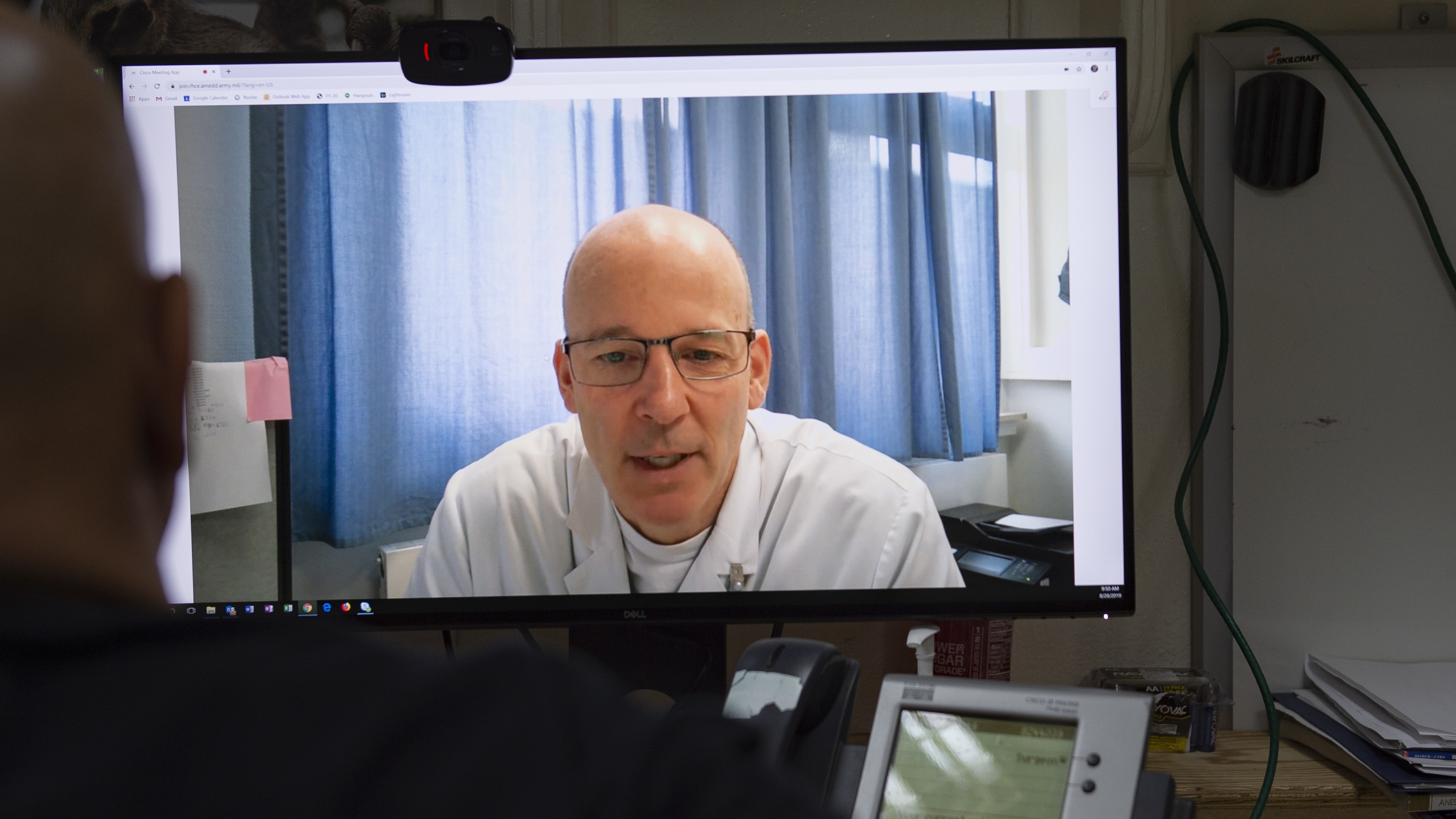 Doctor speaks to patient on telehealth screen