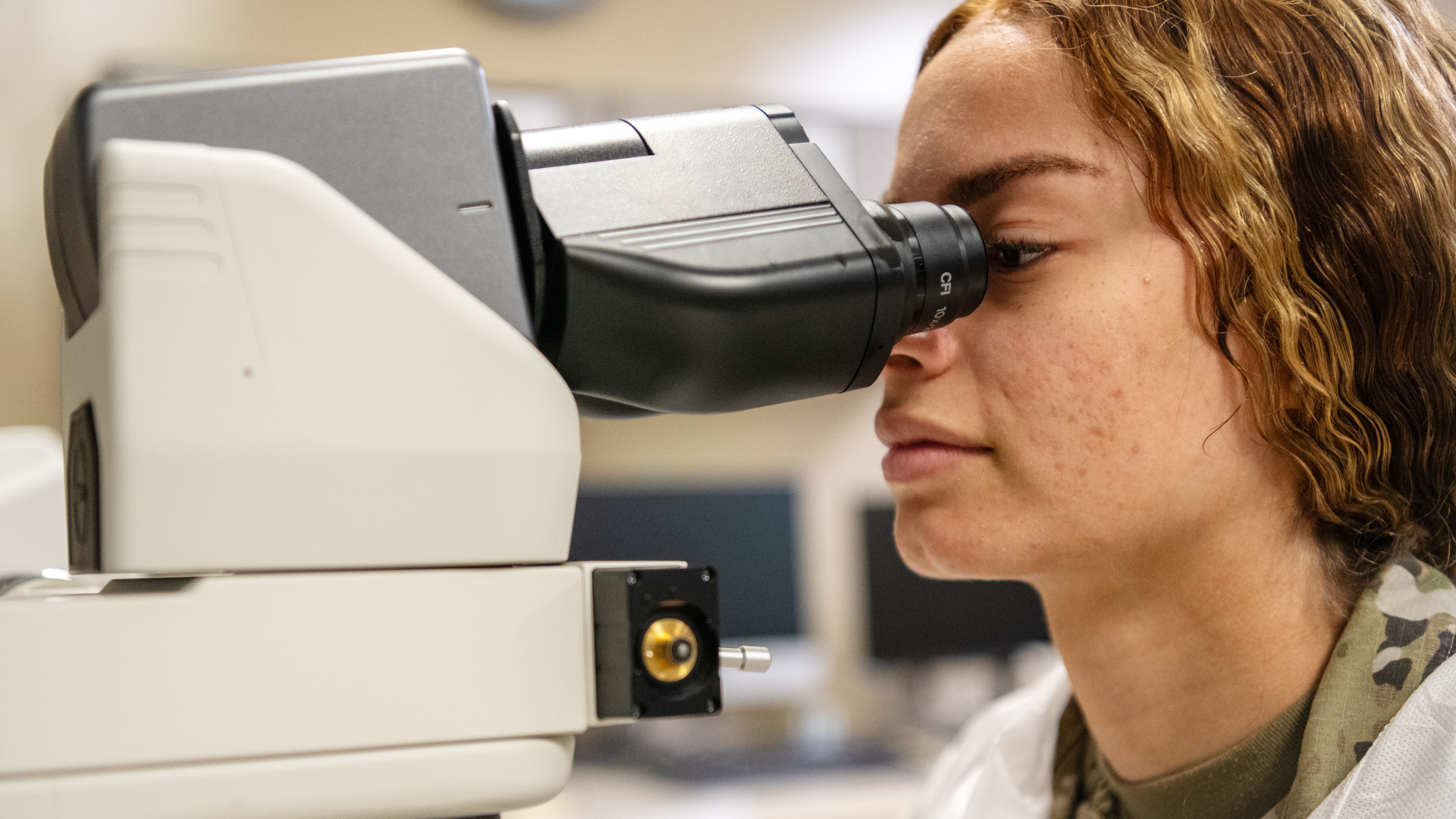 Woman looking into a microscope