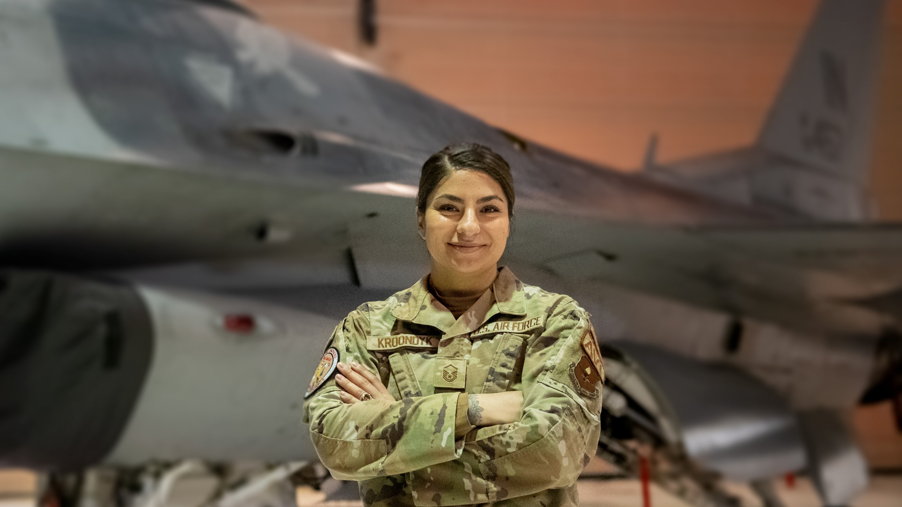 Female pilot standing in front of fighter jet