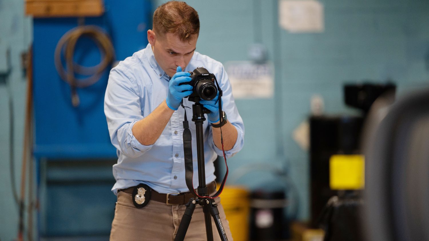 Investigator takes photo at a simulated crime scene