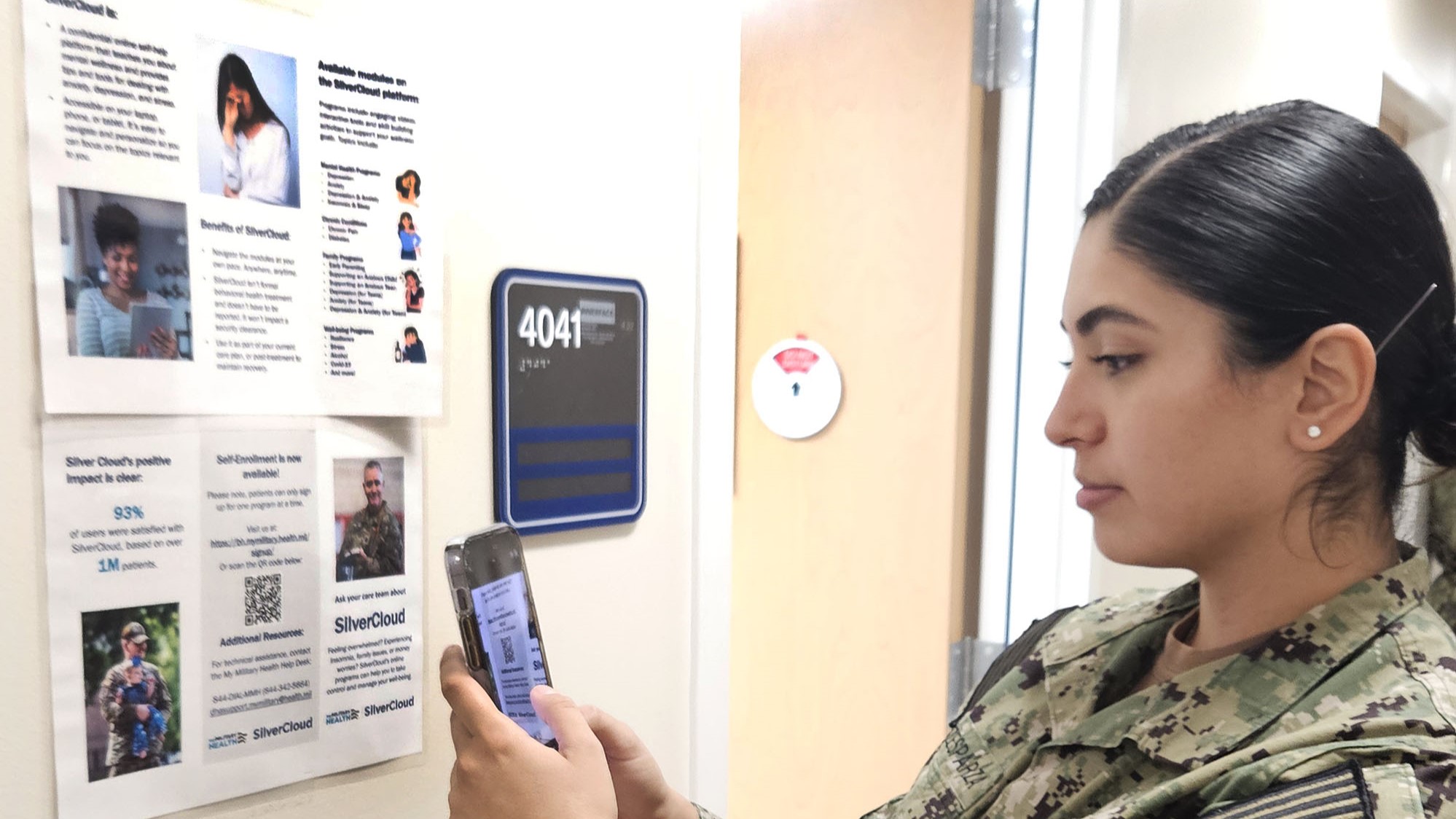 Service member scans a QR code on a SilverCloud poster
