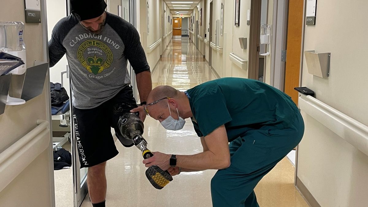 Prosthetics is being fixed by medical personnel.