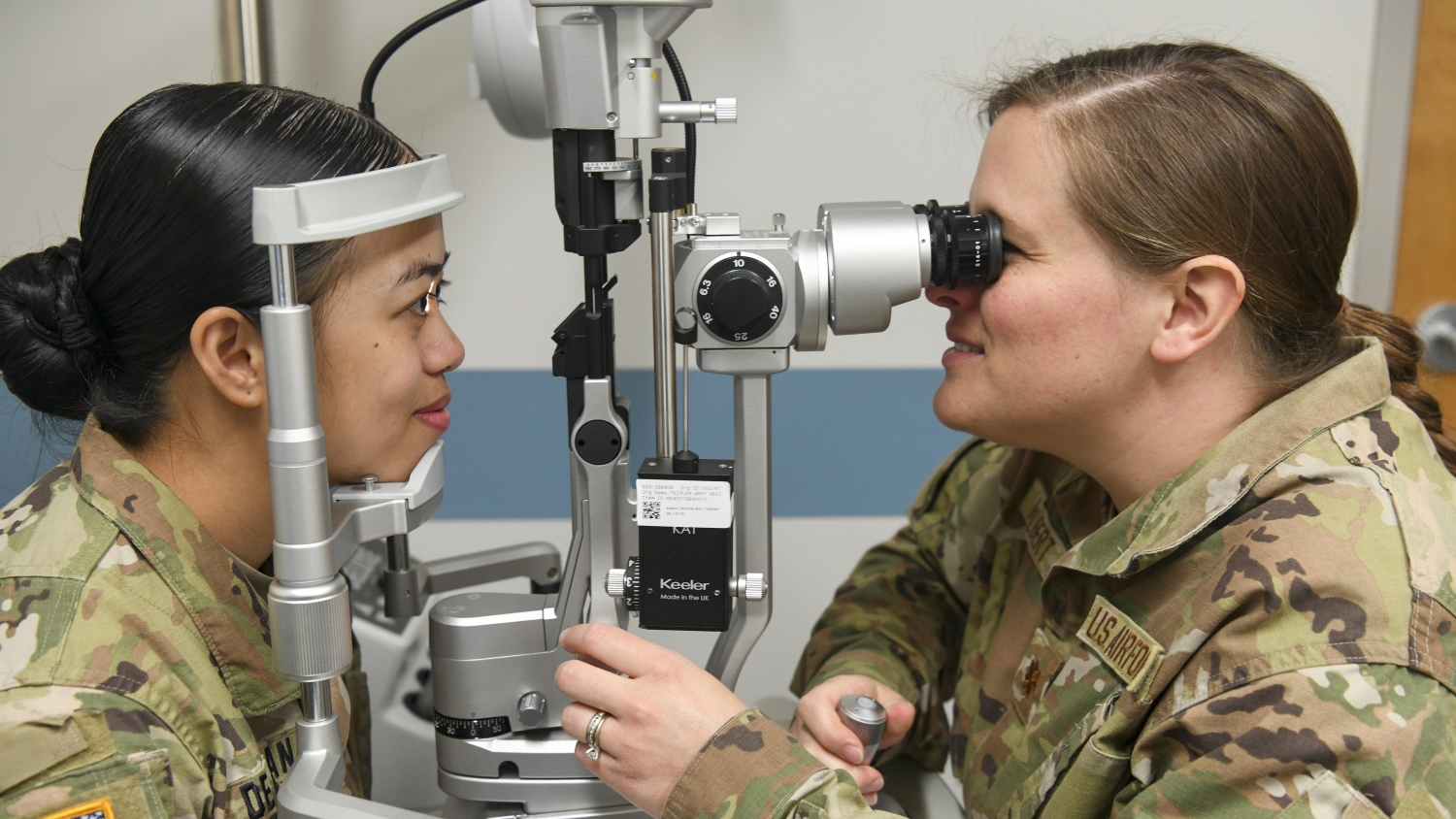soldiers carry equipment through field