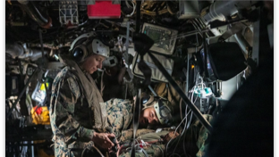 patient being treated inside military aircraft by two medics