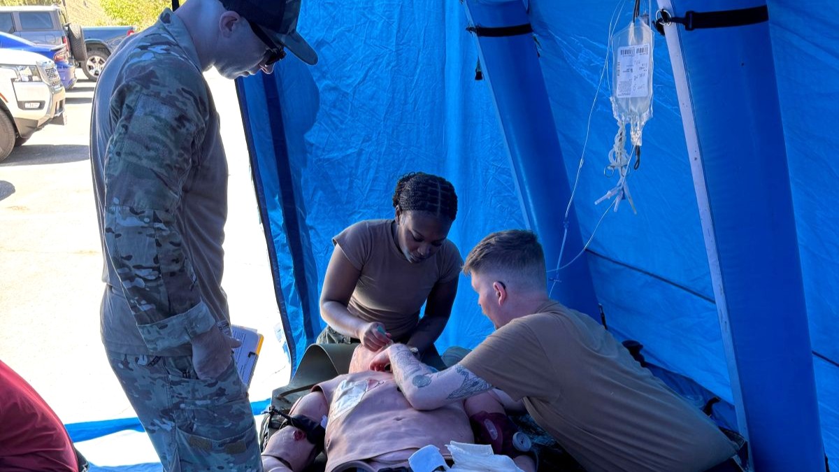 From left, Chief Hospital Corpsman Noah Morrison, Hospitalman Apprentice Amari Carter and Hospital Corpsman 2nd Class Wetherington provide simulated emergency medical treatment to a training mannequin inside a medical tent during a mass casualty exercise at Navy Medicine Readiness and Training Detachment Bridgeport, California, July 27, 2026. The exercise tested casualty assessment, trauma care and team communication to strengthen operational medical readiness. (U.S. Navy courtesy photo).