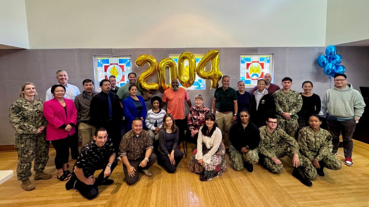 Members of Naval Medical Center San Diego’s (NMCSD) cross-functional onboarding and talent-acquisition team pose for a group portrait at NMCSD, Oct. 14, 2026, during a ceremony celebrating the command surpassing 2,000 civilian personnel. The multidisciplinary team—comprising representatives from the Civilian Human Resources Agency (CHRA), Human Resources Department (HRD), Credentialing, Medical Administration Officers (MAOs), the Drug Testing Program, Personnel Security, and Occupational Health—collaborated over the past two years to streamline recruitment and successfully onboard more than 444 civilian healthcare professionals and support staff. The collective initiative directly advances Defense Health Agency Campaign Order priorities and CORE 15 clinical readiness capabilities by strengthening administrative continuity and operational healthcare delivery across the medical center.