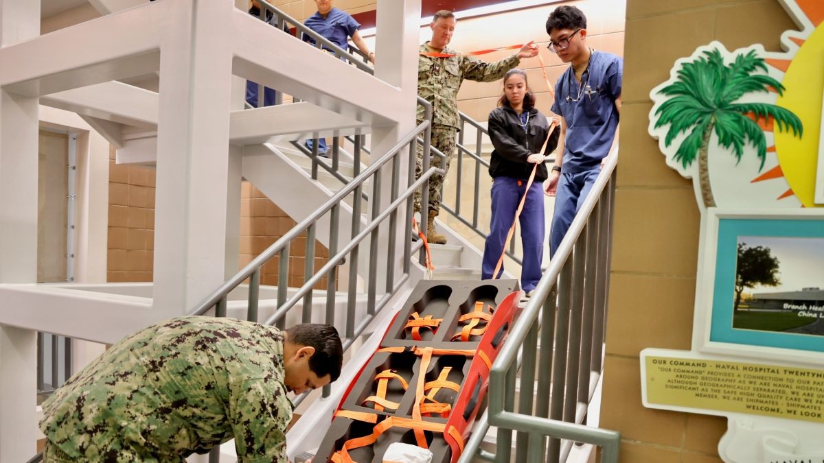 Hospital corpsmen and staff at Naval Hospital Twentynine Palms practice safely transferring patients without the use of elevators during the 2026 Great California ShakeOut earthquake preparedness exercise Oct. 15, 2026. The exercise reinforced emergency response procedures and the hospital's ability to maintain patient safety during a seismic event. (U.S. Navy photo by Christopher Jones, NMRTC/NH Twentynine Palms public affairs officer).