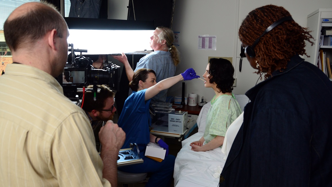 Myna Shegog (right), Captain James A. Lovell Federal Health Care Center sexual assault nurse examiner, and Kurt Uebersax (left), KJU Productions LLC owner, observe a Sexual Assault Forensic Examination (SAFE) scene rehearsal at Lovell FHCC for a Navy training video.