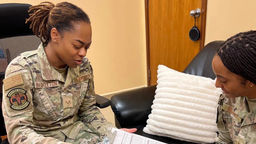 U.S. Air Force Senior Airman Yasmin Freckleton refers to an intake form while speaking with a fellow Airman in a mental health clinic at Ali Al Salem Air Base, Kuwait, March 5, 2025. (Photo courtesy from Senior Airman Yasmin Freckleton)