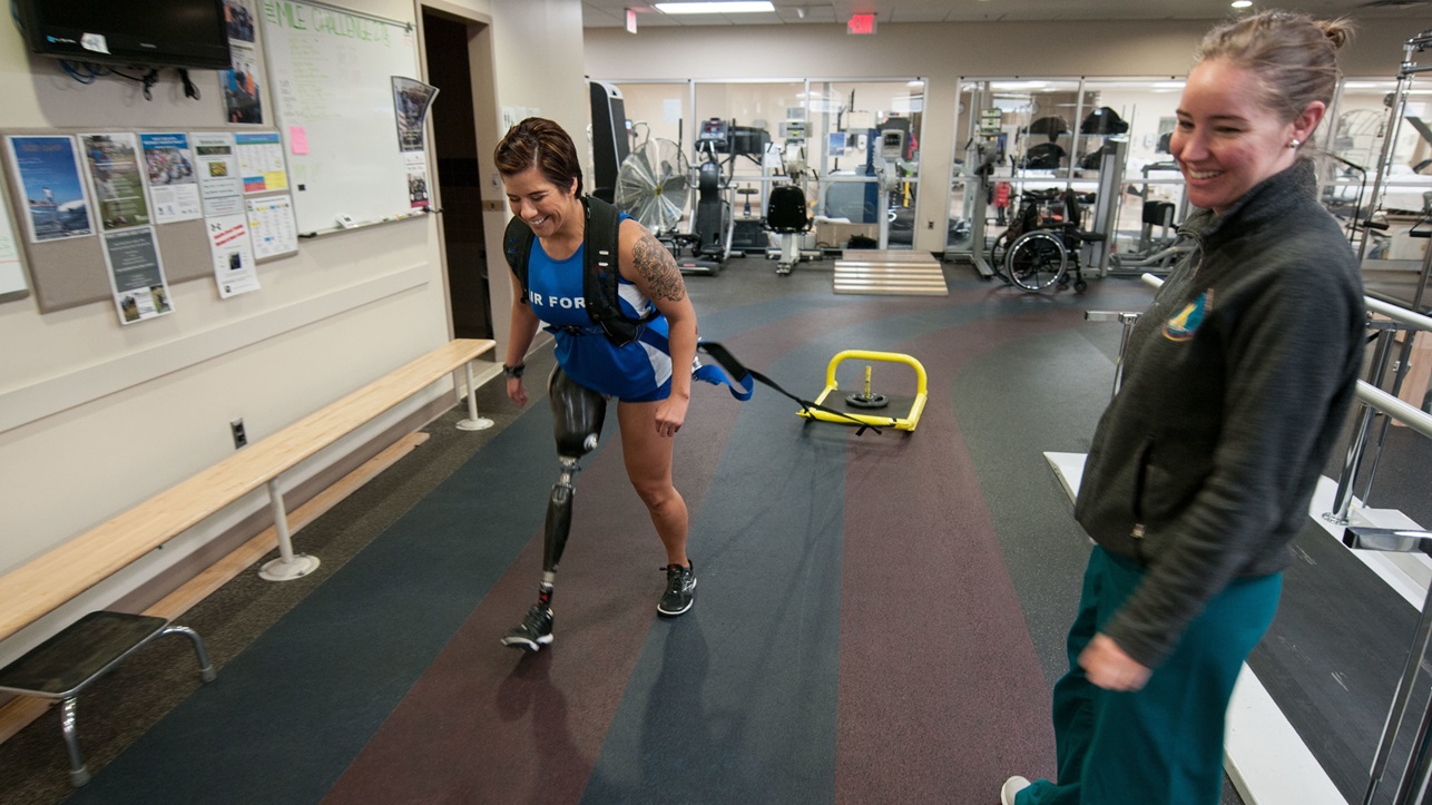 Staff Sgt. Sebastiana Lopez Arellano, a patient at Walter Reed National Military Medical Center, pulls a weighted sled around a track inside the center’s Military Advanced Training Center, which provides amputee patients with state-of-the-art care, in Bethesda, Md., April 13, 2016. Lopez lost her right leg and suffered several other injuries in a motorcycle crash in 2015. She now uses sports and fitness as part of her physical and occupational therapy regimen. (U.S. Air Force photo/Sean Kimmons)