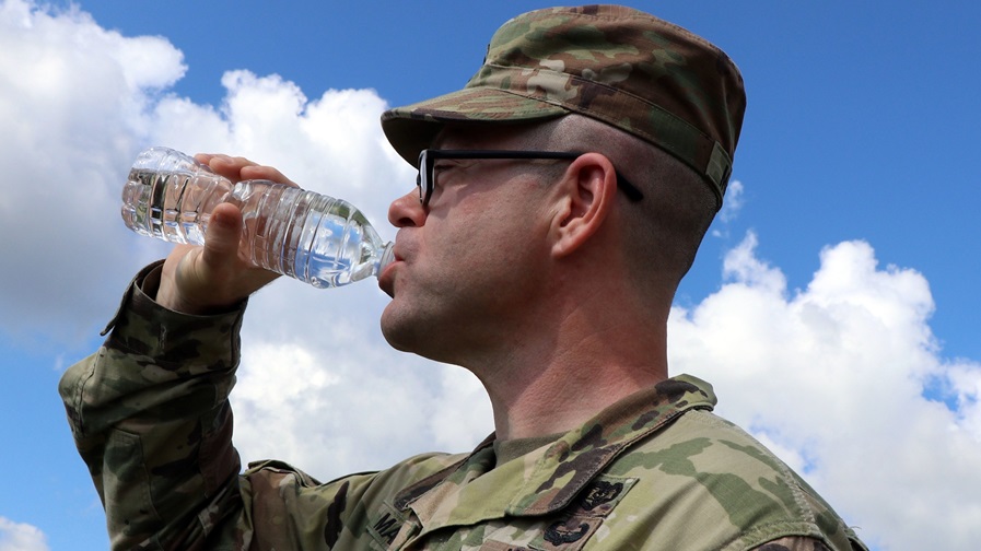 Staff Sgt. Shaun Martin, a combat medic assigned to Blanchfield’s LaPointe Army Medical Home on Fort Campbell, drinks from a 16 ounce bottle of water to maintain his hydration for optimal performance.