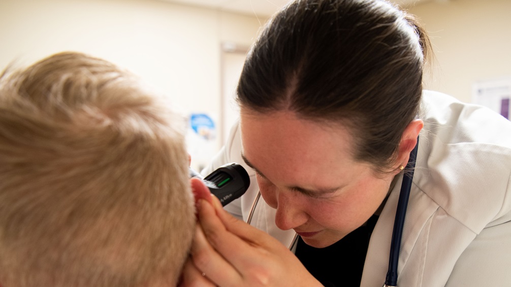U.S. Navy Lt. Kathryn Flynn, Chief of Residents, Internal Medicine Residency Program, examines a patient at Walter Reed National Military Medical Center, Jan. 24, 2025. Flynn is assigned to Navy Medicine Readiness and Training Command (NMRTC), Bethesda's Expeditionary Medical Unit (EMU-2) Bethesda, an operational unit ready to support missions for expeditionary medicine. NMRTC Bethesda is mission is to maximize warfighter performance through optimized medical readiness tailored to operational requirements; enhance the readiness of the medical force to sustain expeditionary medical capability; and train and develop the Navy Medicine Force. (U.S. Navy Photo by Mass Communication Specialist 1st Class Toni N. Burton)