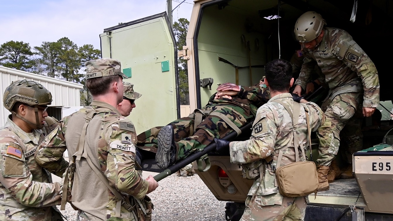 Soldiers from the 115th Field Hospital and medics from the 1st Battalion, 509th Infantry Regiment remove casualties from a field litter ambulance for triage, evaluation, and care during during Operation Forge, March 3 at the Joint Readiness Training Center and Fort Johnson, Louisiana.