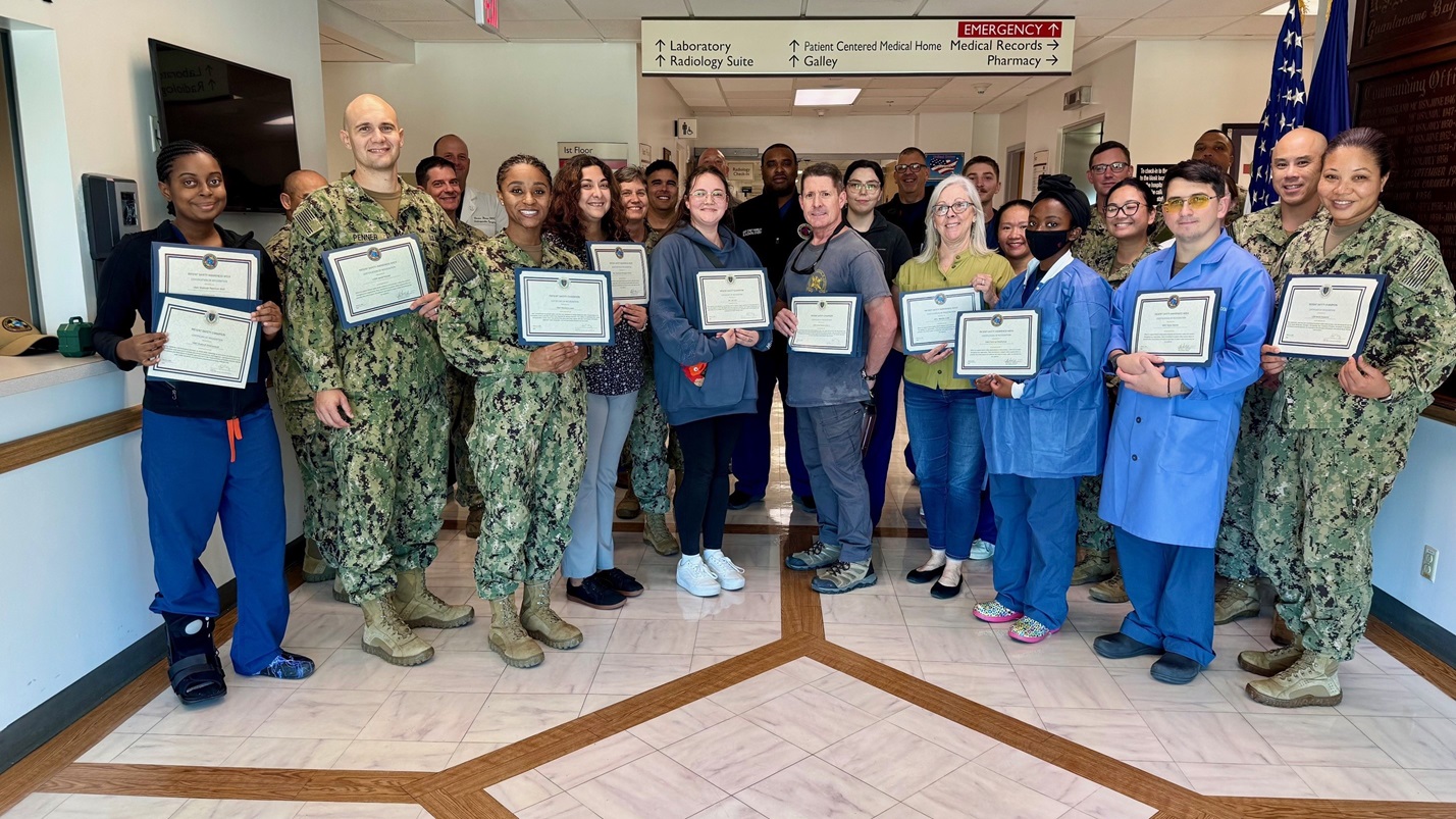 Employees at U.S. Naval Hospital Guantanamo Bay display their Patient Safety Awards, presented Mar. 20, 2025. The awards were given to recognize each member for their contributions to patient safety awareness events or for a "Good Catch" by identifying and reporting safety events or potential problems before they could cause harm to a patient. (U.S. Navy photo by Emily McCamy/released)