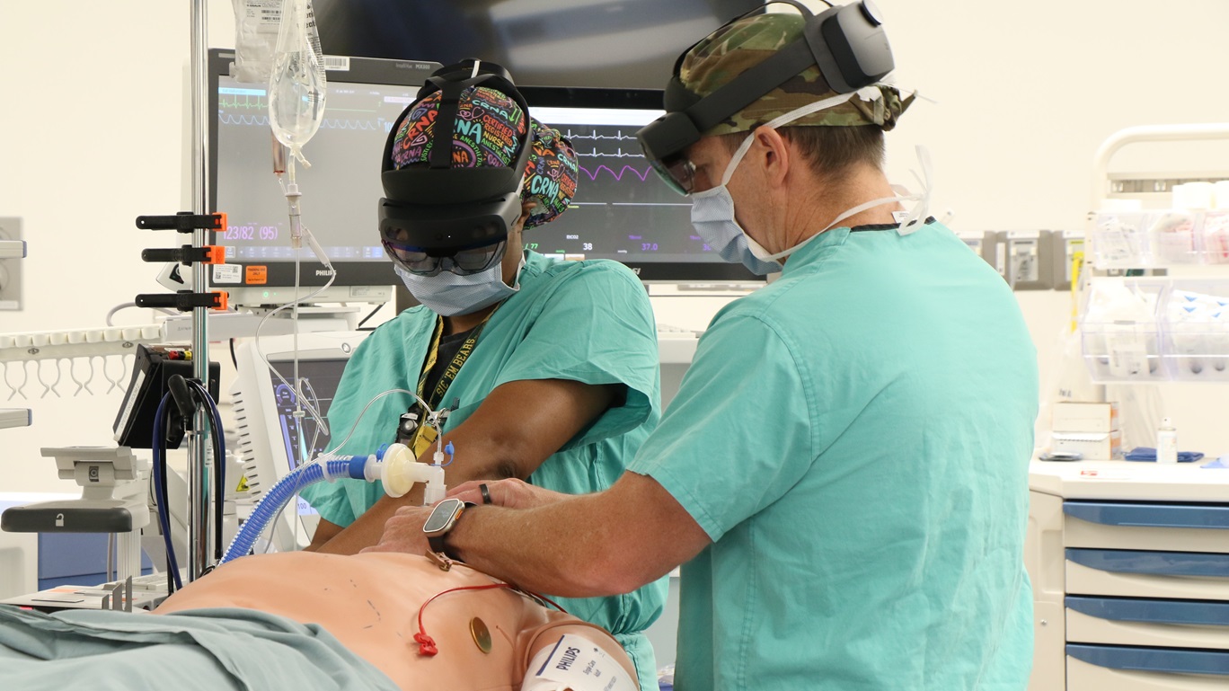 Maj. Tenesha Middleton, a Certified Registered Nurse Anesthetist (CRNA) at WBAMC, and her colleague, wear the virtual reality headset and prepare a simulation patient for surgery during a simulated training scenario at William Beaumont Army Medical Center, March 26, 2025.