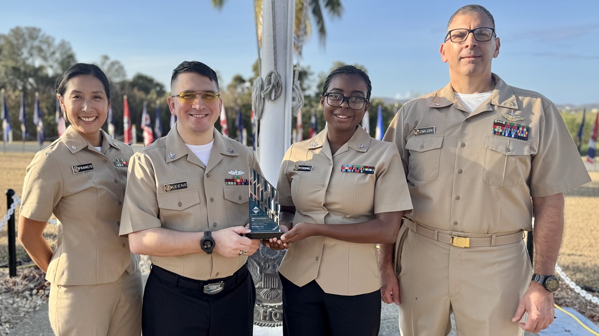 From left, Cmdr. Jennifer Francis, Hospital Corpsman 2nd Class Taylor Keene, Hospital Corpsman 2nd Class Shakirah Peterson-Wall and Cmdr. James Zmijski, members of U.S. Navy Medicine Readiness and Training Command, display the Association of Perioperative Registered Nurses “Go Clear” Award, March 28, 2025. The award recognized the operating room team for their work to implement advanced smoke evacuation technology and demonstrate commitment to surgical safety. (U.S. Navy photo by Emily McCamy)