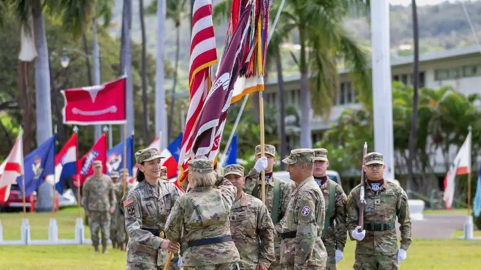 Lt. Gen. Mary K. Izaguirre, U.S. Army Surgeon General and Commanding General, U.S. Army Medical Command, passes the unit colors to incoming commander, Brig. Gen. Deydre Teyhen, at Palm Circle, Honolulu, Hawaii. Outgoing commander, Brig. Gen Bill Soliz, relinquished his command in a Change of Command ceremony on Apr. 22, 2025. (photo by Tripler Army Medical Center)