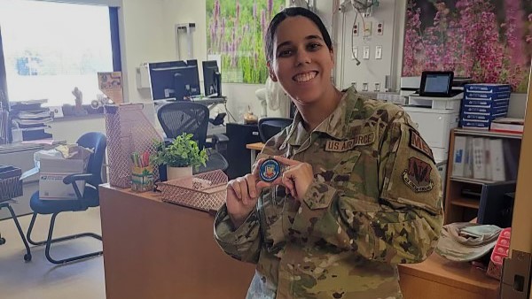 U.S. Air Force Capt. Zanetta Foster holds a coin she received from the Air Combat Command Surgeon General, Col. Raymond J. Clydesdale, for improving standard procedures in the labor and delivery unit at Mike O’Callaghan Military Medical Center, Nellis Air Force Base, Nevada, October 2024. (Courtesy photo from U.S. Air Force Capt. Zanetta Foster)