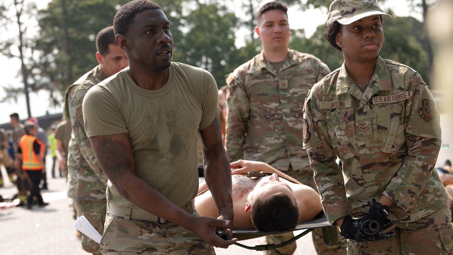 Airmen from the 628th Medical Group carry a patient during a medical exercise at Joint Base Charleston, South Carolina, May 8, 2025. The 628th MDG showcased their capabilities to provide life-saving care and rescue in response to a massive mishap. (U.S. Air Force photo by Staff Sgt. James E. Harris III)