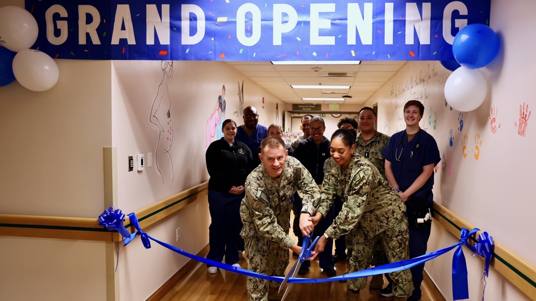 Capt. Daniel Clark (left), commanding officer of Naval Hospital Twentynine Palms, and Cmdr. Christine Higgins (right), Maternal-Infant Nursing Department head and staff certified nurse midwife, cut the ribbon during a ceremony on May 29 marking the relocation and revitalization of the hospital’s Multi-Service Ward.