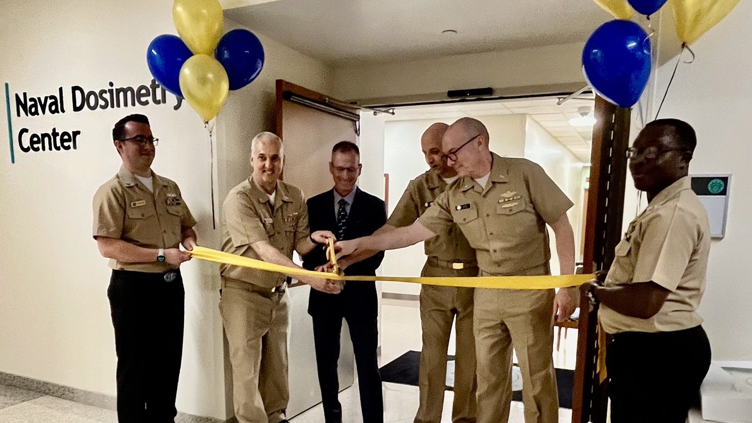 Cmdr. Jeffrey A. Delzer, officer-in-charge of the Naval Dosimetry Center (NDC), cuts the ribbon alongside the Defense Health Agency and NDC leadership to officially open the center’s new, state-of-the-art facility at Walter Reed National Military Medical Center.