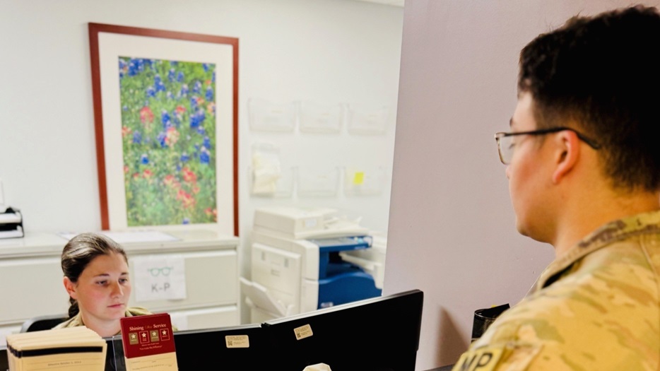 Munson Army Health Center Public Health Nurse 1st Lt. Kennedy Reeves checks-in Army Corrections Brigade Soldier Spc. Philippe Tirgari for hearing and vision screening at the military treatment facility on Fort Leavenworth, Kansas, June 25.