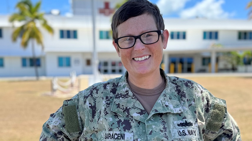 Cmdr. Crystal Saraceni, a member of U.S. Navy Medicine Readiness and Training Command, Guantanamo Bay, stands in front of U.S. Naval Hospital Guantanamo Bay