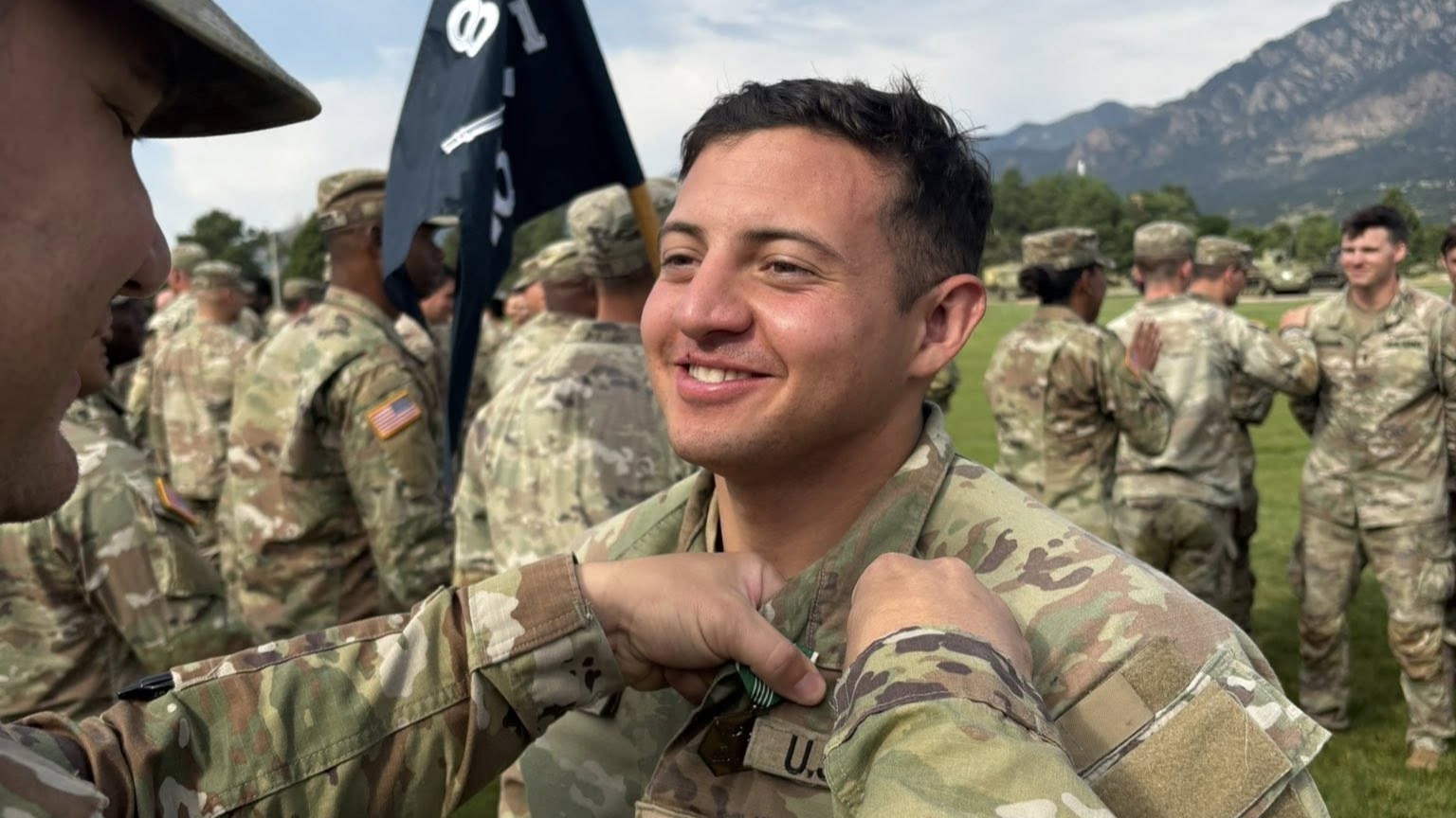 Sgt. 1st Class Christopher Stewart, the NCO in charge of the DiRaimondo Main Clinic, pins the Expert Field Medical Badge on Staff Sgt. Ezequiel Bravo, a 68W Combat Medic and NCO in charge of the DiRaimondo Support Clinic. Bravo participated in the Expert Field Medical Badge competition at Fort Carson Aug. 11-15, 2025, and not only earned the badge, he was named Top Doc for the competition.