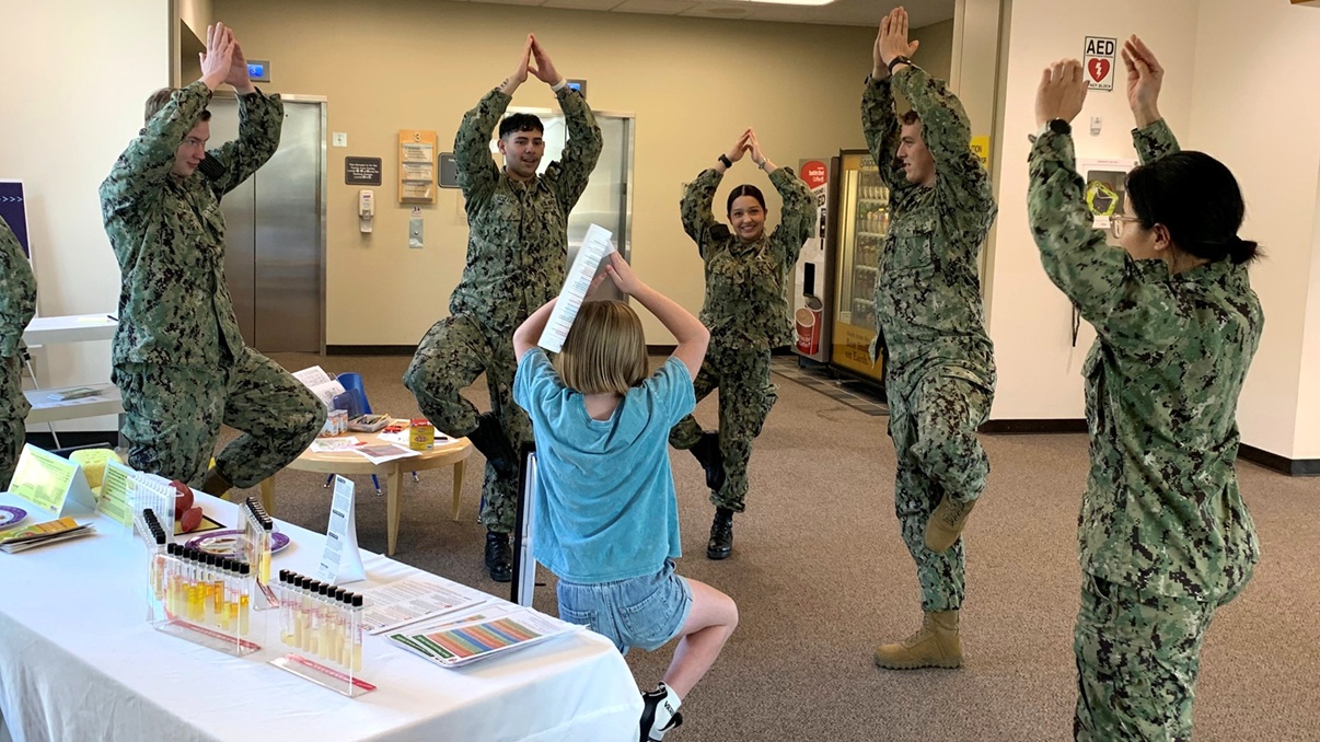 Seeing the forest with all the trees…hospital corpsmen assigned to Naval Hospital Bremerton join a young beneficiary in an impromptu tree pose designed to test balance and stability during Health Promotion’s Health Fair held in conjunction with the September focus on National Childhood Obesity Awareness Month. 