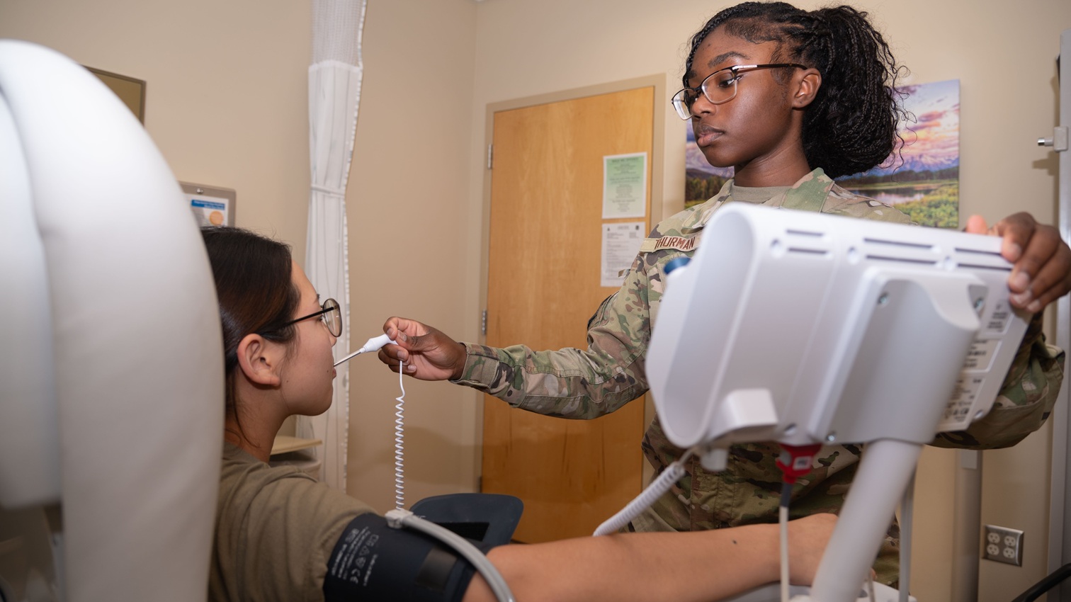 U.S. Air Force Airman 1st Class Shemariah Thurman, Aerospace Medical Technician with 30th Operational Medical Readiness Squadron, checks a patient's vitals at Vandenberg Space Force Base, Calif., Sept. 24, 2025. This check was for a routine medical exam. (U.S. Space Force photo by Staff Sgt. Daekwon Stith)