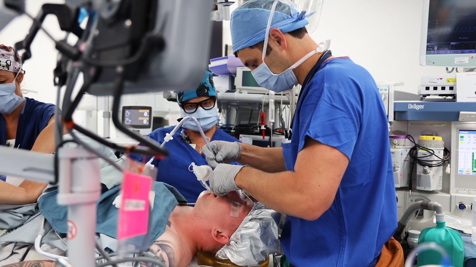Lt. Chris DeBarge, first year anesthesia resident, intubates a patient as part of preparation for a jaw-in-a-day procedure at Naval Medical Center San Diego. (DoW photo by Regena Kowitz)