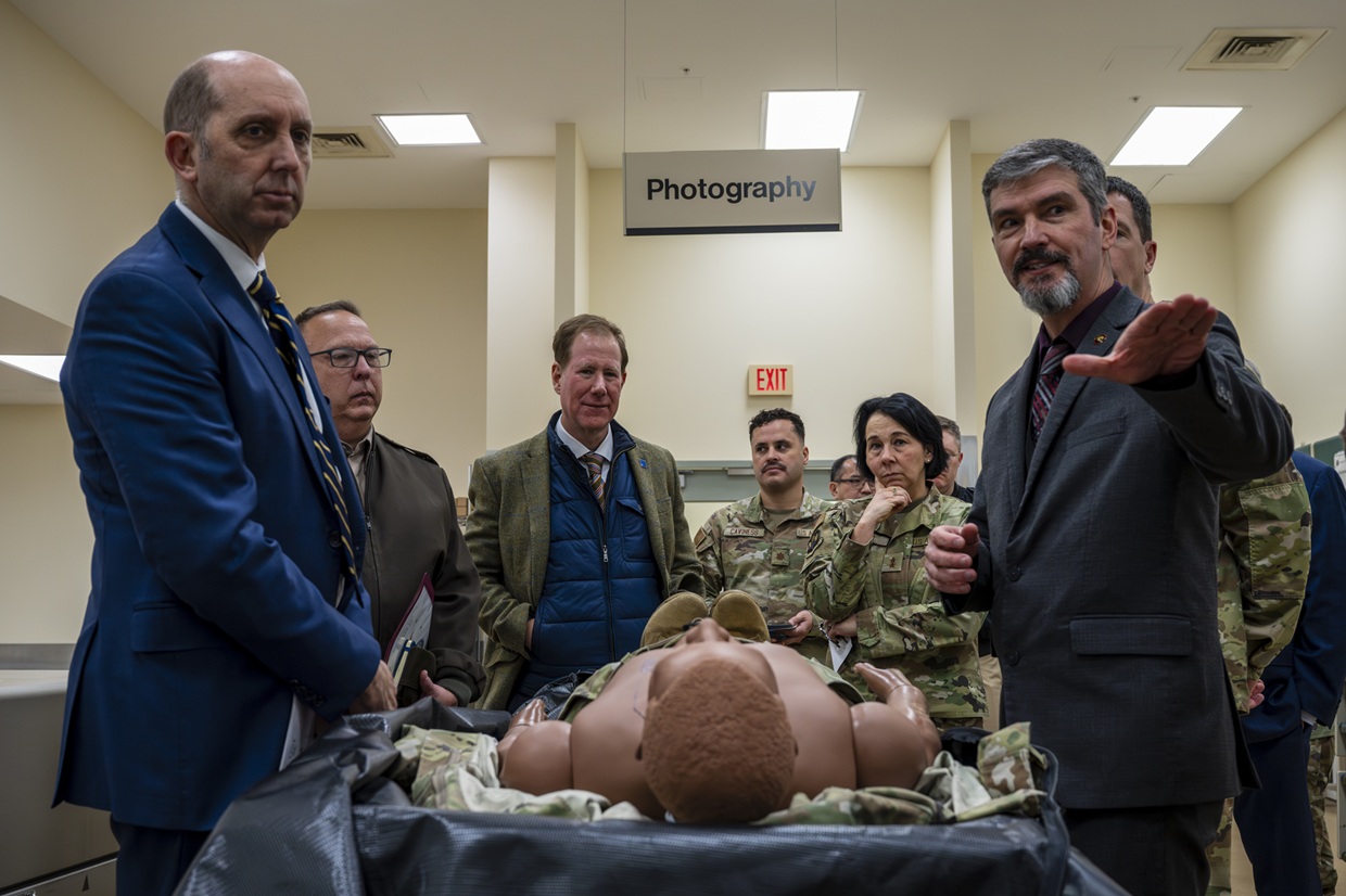 Dr. Edward Mazuchowski (right), Armed Forces Medical Examiner System deputy medical examiner, briefs Dr. Stephen Ferrara (left), Acting Assistant Secretary of War for Health Affairs, on the unique mission of the Forensic Pathology Investigations section of the AFMES on Dover Air Force Base, Delaware, Dec. 12, 2025. Dr. Ferrara visited the AFMES along with U.S. Air Force Maj. Gen. Jeannine Ryder, Acting Assistant Director of Healthcare Administration for the Defense Health Agency, as well as members of the Uniformed Services University of the Health Sciences, to discuss the AFMES mission set and a variety of other topics. (U.S. Air Force photo by Staff Sgt. Noah D. Coger)