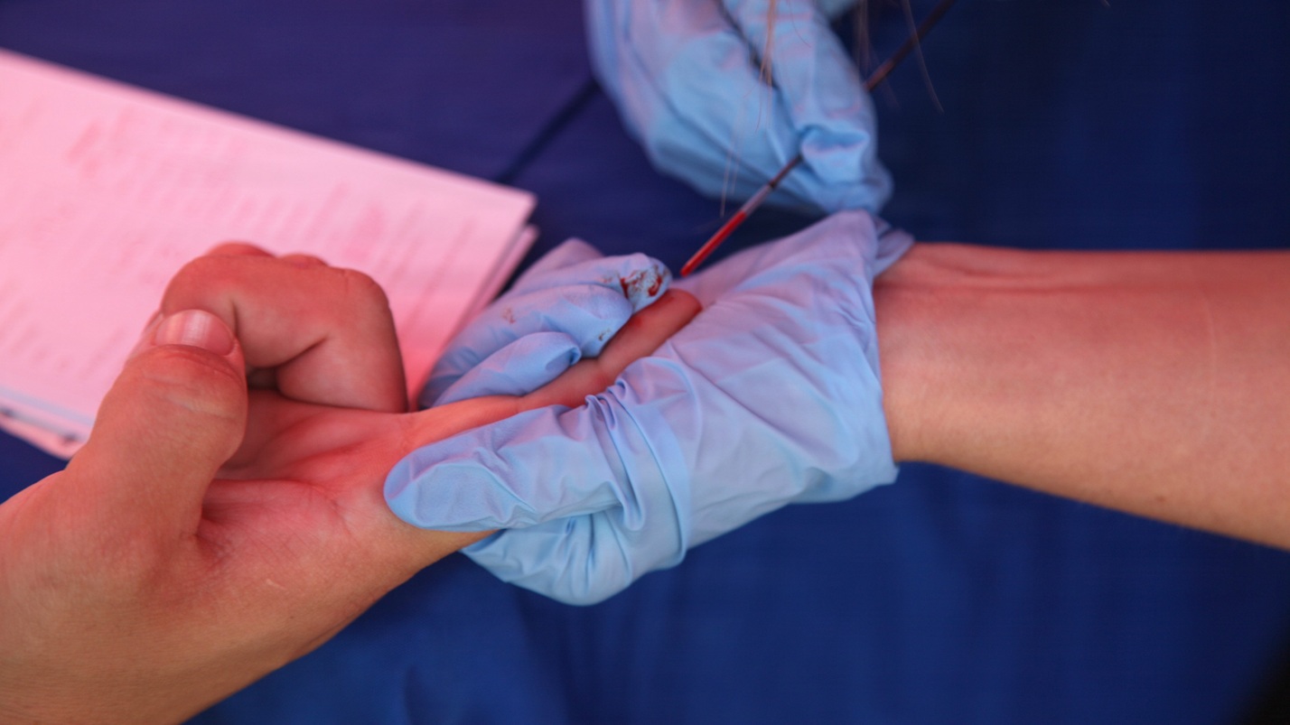 Person getting their finger pricked for a blood test