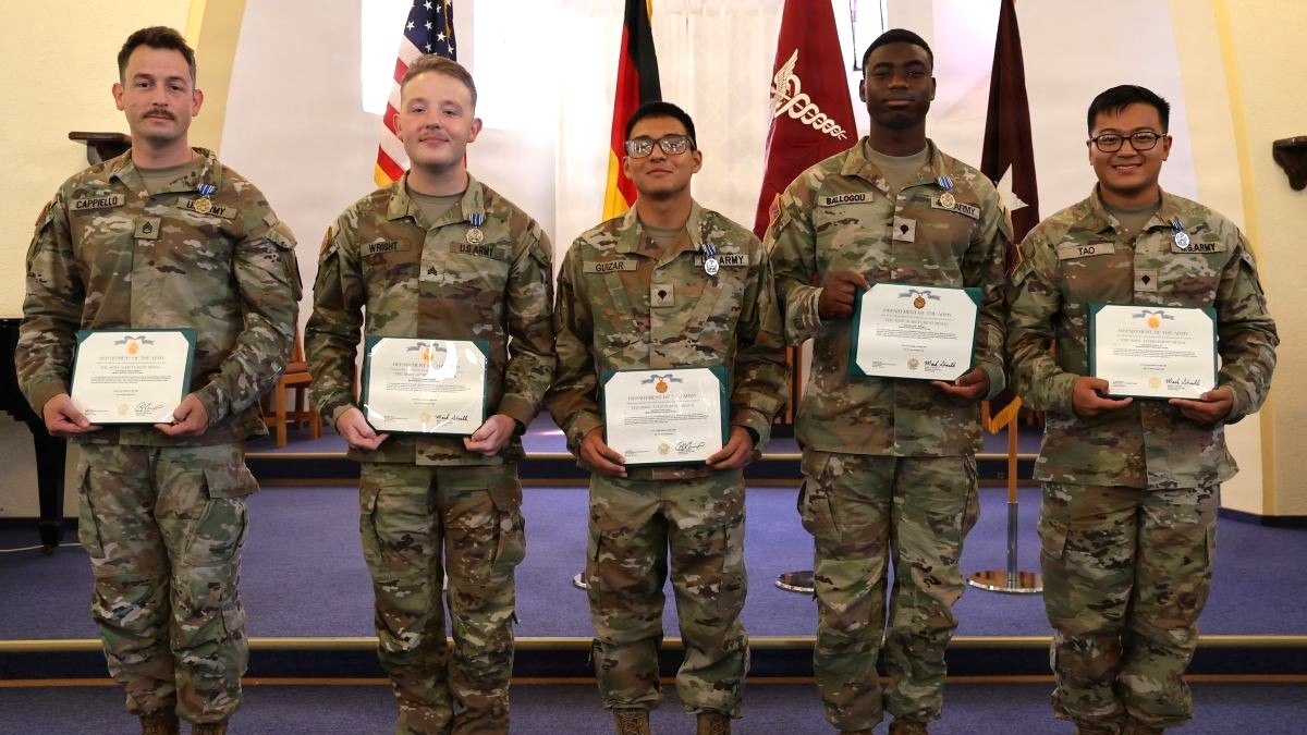 LANDSTUHL, Germany — Staff Sgt. Joseph Cappiello, Sgt. Zachary Wright, Spc. Carlos Guizar, Spc. Kofi Ballogou, and Spc. Brucelee Tao, Landstuhl Regional Medical Center Soldiers pose after receiving the Army Achievement Medals from Brig. Gen. Mark Stackle, commander of Medical Readiness Command-Europe, and Command Sgt. Maj. Kalani Kalili, senior enlisted advisor for MRC-EUR, during an awards ceremony at the LRMC Chapel Aug. 11. The Soldiers were recognized for their exceptional performance and dedication , which contributed to a third-place finish at the 2026 U.S. Army Medical Command Best Squad Competition at Fort Benning, Georgia.