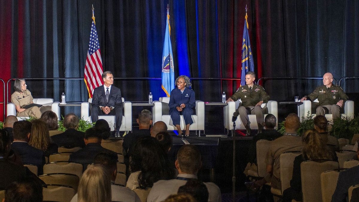 Rear Adm. Tracy Farrill, director of Defense Health Agency’s Office of Warfighter Health Advantage and the Military Health System Digital Functional Champion, moderates a panel of service surgeons general and senior leaders from the services’ medical commands at the 2026 Defense Health Information Technology Symposium, held in New Orleans, Louisiana, Aug. 11. On the panel were: Dr. Michael McGinnis, executive director of U.S. Navy Bureau of Medicine and Surgery; Air Force Brig. Gen. Gwendolyn Foster, chief of Air Force Nurse Corps; Army Brig. Gen. Jonathan Taylor, deputy commanding general of U.S. Army Medical Command; and Army Maj. Gen. Clinton Murray, Joint Staff Surgeon.