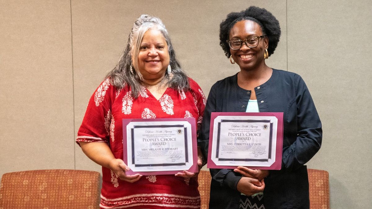 Melanie Stewart, left, and Corretta Custis, right, display their People’s Choice Awards at Kenner Army Health Clinic. Both were recognized for their efforts to improve care coordination and access to patient care.