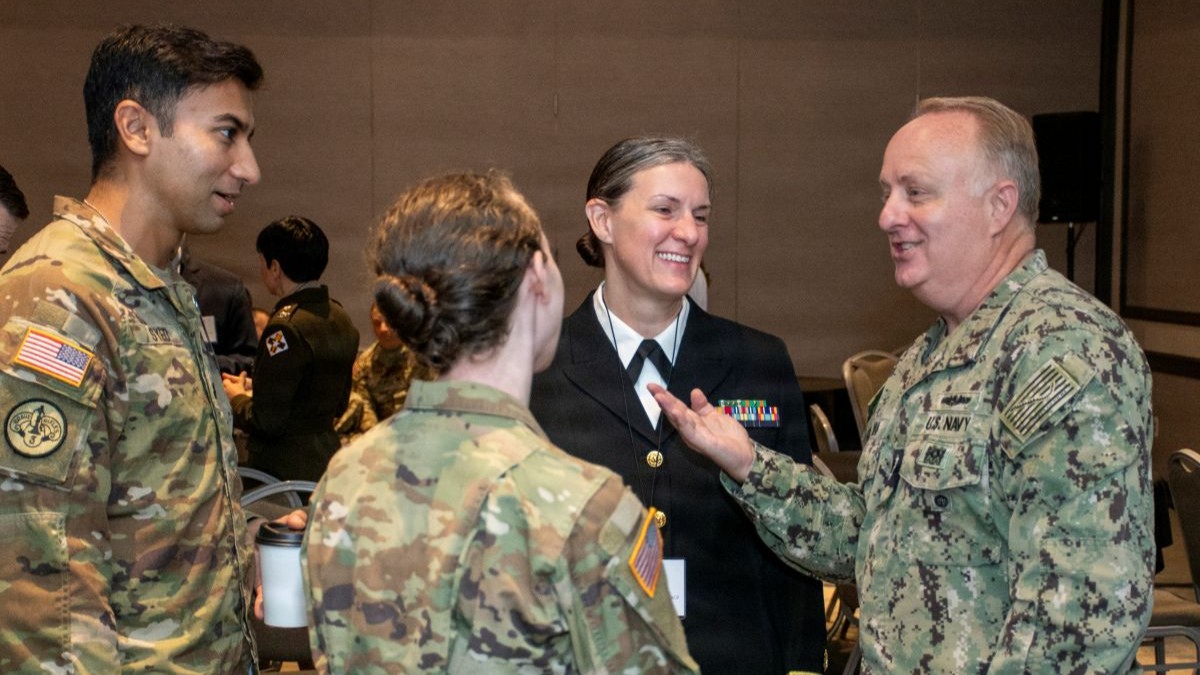 Navy Vice Adm. Darin Via, director of the Defense Health Agency, speaks with emerging military healthcare leaders at the 2026 Tri-Service Chapters Annual Scientific Meeting in Bethesda, Maryland, Aug. 26. Opening the meeting, Via stressed the role of medical leaders in combat power and delivery of warfighter medical readiness: “You all will save more lives on the future battlefield … you will keep more fighters in the fight, and that is how we will win the war.”