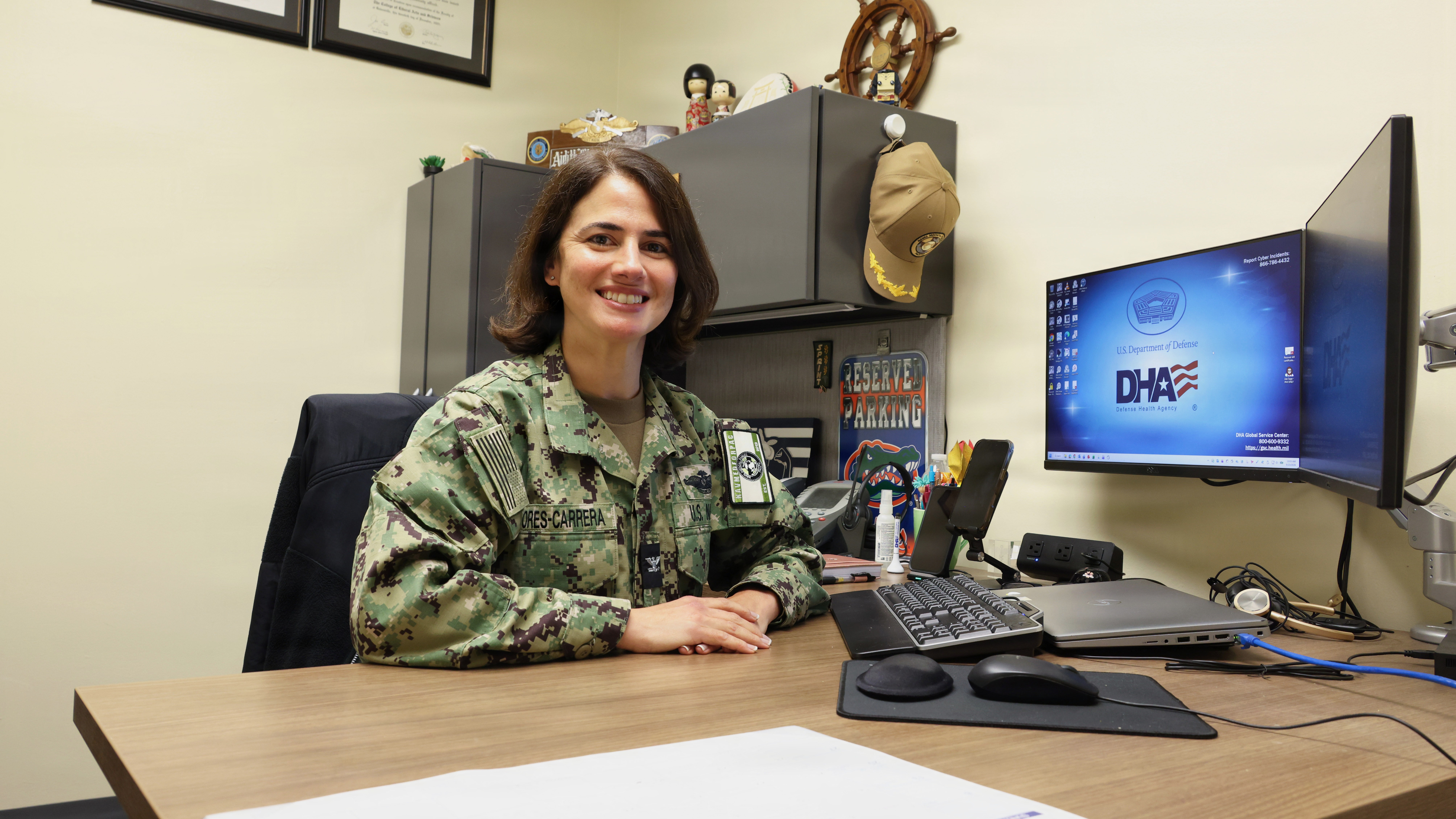 Navy Capt. Aidith Flores-Carrera, an active-duty Navy psychiatrist and native of Miami, Florida, poses for a picture in her office. Psychiatrists are physicians who evaluate the biological and physiological pieces of mental health, including sleep, neurochemistry, underlying medical conditions and medication interactions, and they work alongside psychologists, social workers, counselors and primary care managers. Many, including Flores-Carrera, provide psychotherapy as well. She is the senior mental health executive for Naval Medical Forces Pacific, and the mental health lead for Defense Health Network Pacific Rim, which spans nine military hospitals and clinics across the U.S. West Coast, Guam, and Japan. (DoW photo by Regena Kowitz)