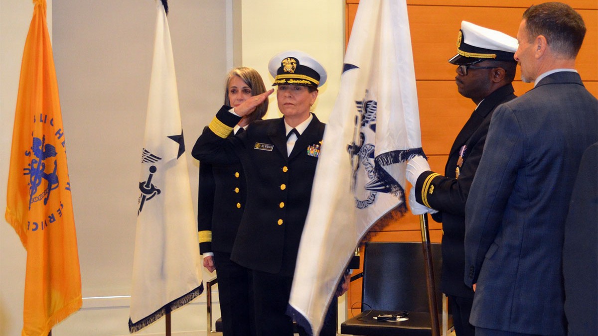 U.S. Public Health Service Rear Adm. Sara Newman, director of Defense Health Agency-Public Health, reaffirms the oath of office and salutes the U.S. Public Health Service flag during her promotion ceremony at the Defense Health Headquarters in Falls Church, Virginia, Sept. 25, 2026. Newman was promoted to the rank of rear admiral (lower half) during the event. (Defense Health Agency-Public Health photo by Tanisha Blaise)