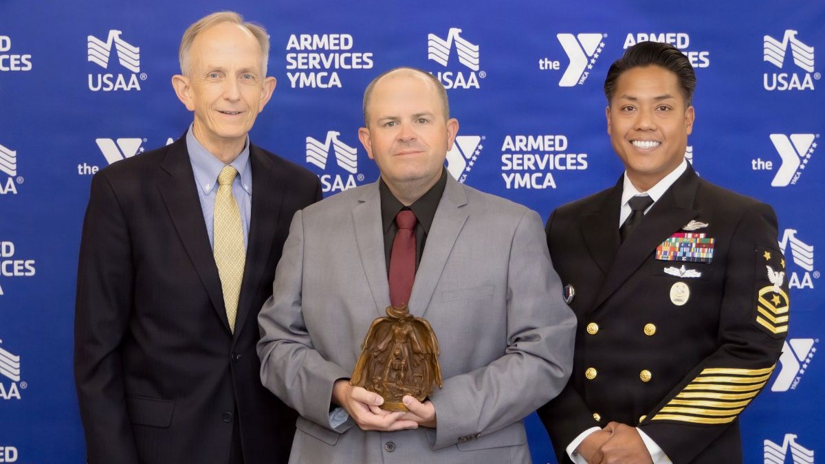 Courtesy Photo | Dr. David Smith, Defense Health Agency deputy director, Bradley Reddall, and Force Master Chief PatrickPaul C. Mangaran, DHA command senior enlisted leader, pose for a photo at the Armed Services YMCA 2026 Angels of the Battlefield Gala in Arlington, Virginia, Sept. 23. Reddall, a paramedic with the 412th Medical Group at Edwards Air Force Base, was presented with the civilian award for lifesaving actions after a crash outside of the base.