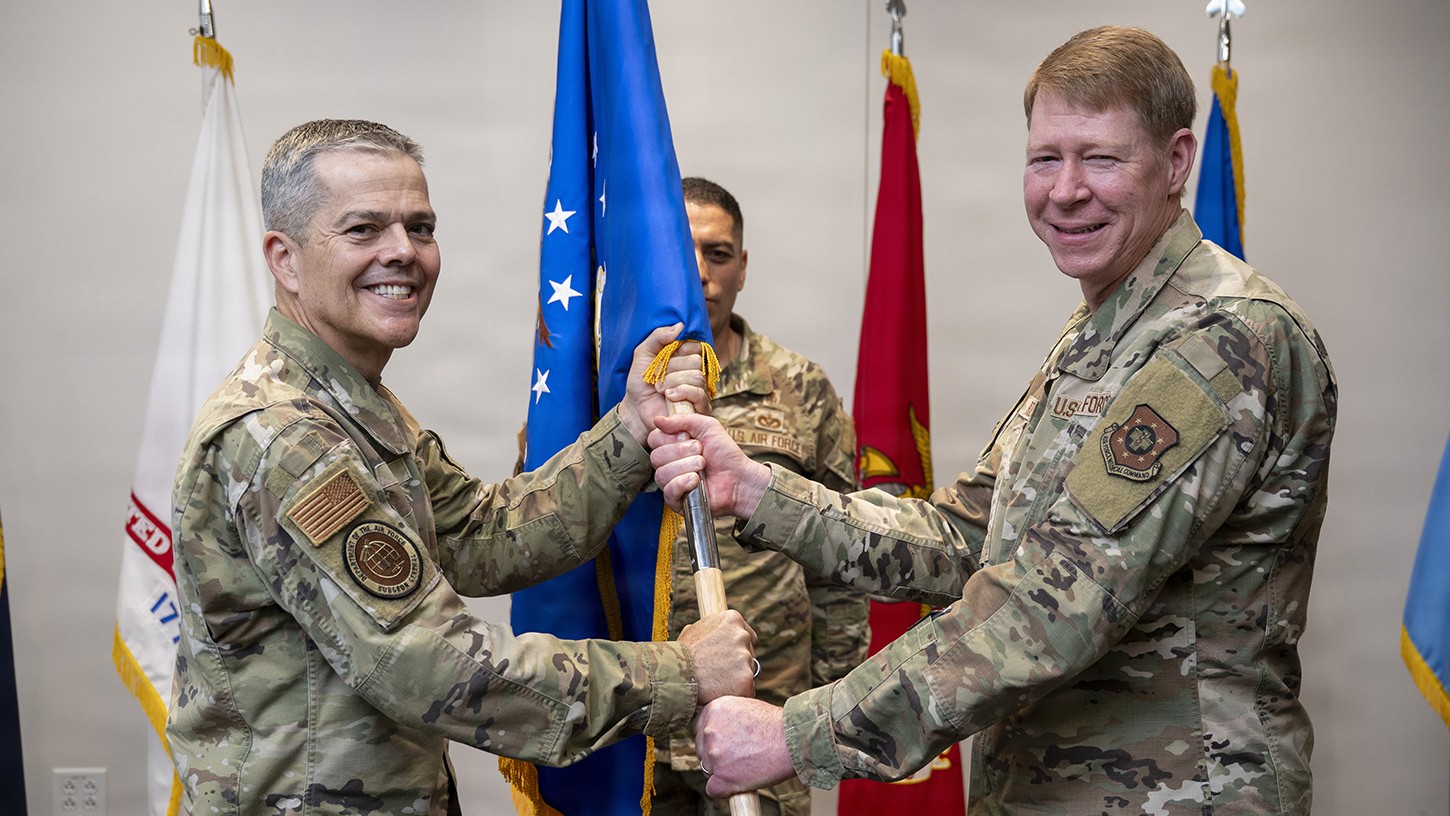 Lt. Gen. John J. DeGoes, Air Force Surgeon General and commander, Air Force Medical Command, hands the guidon to Brig. Gen. Robert K. Bogart during a change of command ceremony for Medical Readiness Command Alpha in San Antonio, Texas, April 1, 2026.