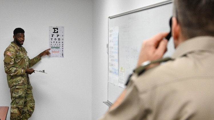 U.S. Army Spc. Starmoon Roger, a healthcare specialist with the 3rd U.S. Infantry Regiment, administers a vision test to a National Defense University service member at a medical readiness rodeo held at Fort Lesley J. McNair in Washington, D.C., on Aug. 4, 2025. Medics and staff addressed medical readiness at eight assessment stations that included patient registry, hearing, immunizations, lab, and vision. The rodeo provided vital benefits for both service members and medics to enhance warfighter readiness. (Defense Health Agency photo by Michelle Gonzalez)
