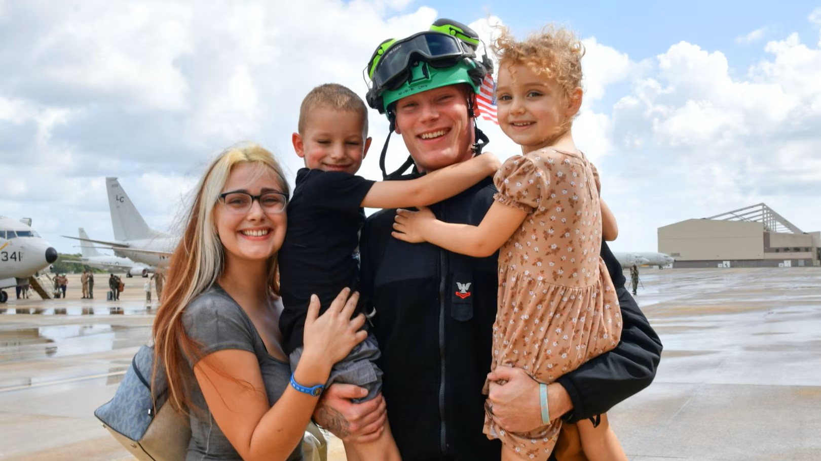 Smiling military family with two young children