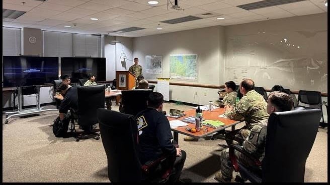 Soldier speaks to a room of colleagues