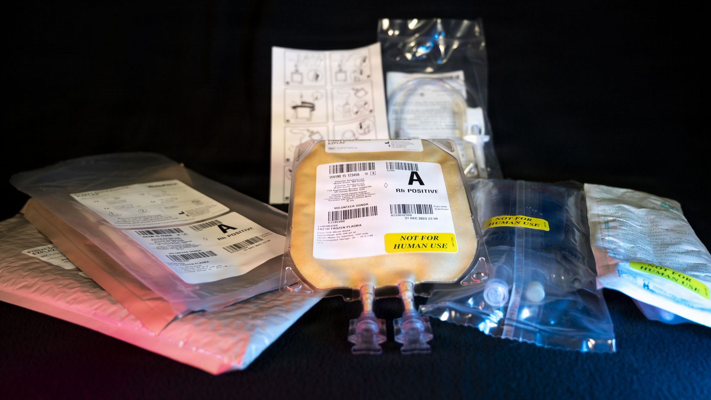 A prototype Freeze-Dried Plasma transfusion kit sits on display, Fort Detrick, Md., Jan. 21, 2026. Blood replacement therapies are a top-tier priority for the Joint Services and U.S. Combatant Commands. FDP, managed by the Defense Health Agency’s Operational Medical Systems Program Management Office, is a shelf-stable plasma designed for use in far-forward environments, potentially saving lives during future conflicts by enabling quicker access to this vital resource while simultaneously easing the logistical burden of transporting traditional blood products. OPMED’s Warfighter Protection and Acute Care Project Management team, in partnership with stakeholders across the Department of War and development industry, have worked to increase commercial availability of FDP during the past several years to fill critical capability gaps for frontline medical providers as they prepare for future conflicts in remote, austere environments like the Indo-Pacific and Arctic regions of the globe. As part of DHA, OPMED partners with stakeholders across the Joint Force to develop, acquire, and field medical devices, treatments, and frontline care solutions for military medical providers to fill capability gaps with the speed of relevance. (Defense Health Agency Photo by Cameron E. Parks/Released)
