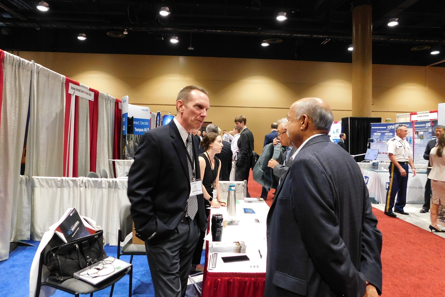 Two men talking in an expo hall